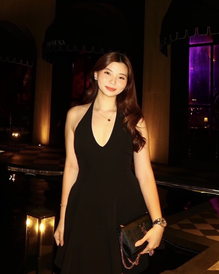 Jenelle Sy, UGC creator and Cabana Club event director, in a black dress at an evening event
